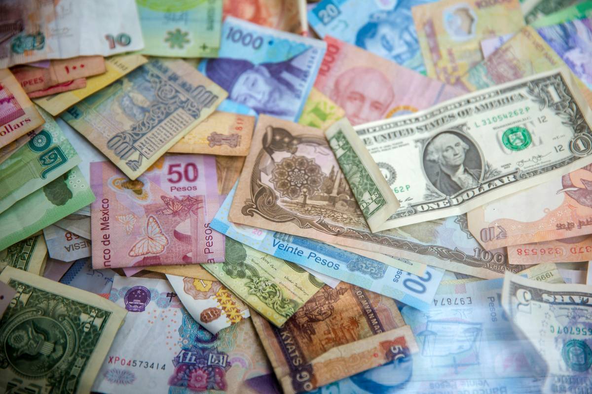 Traveler using foreign exchange insurance policy at international airport counter