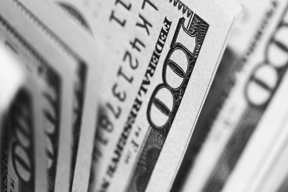Traveler using mobile app to track secure currency exchange with insurance protection badge