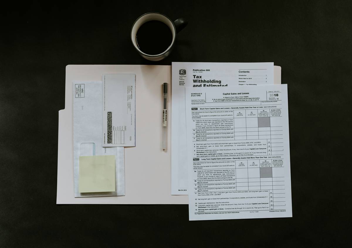 Currency exchange car insurance document next to passports and foreign coins on a car rental counter