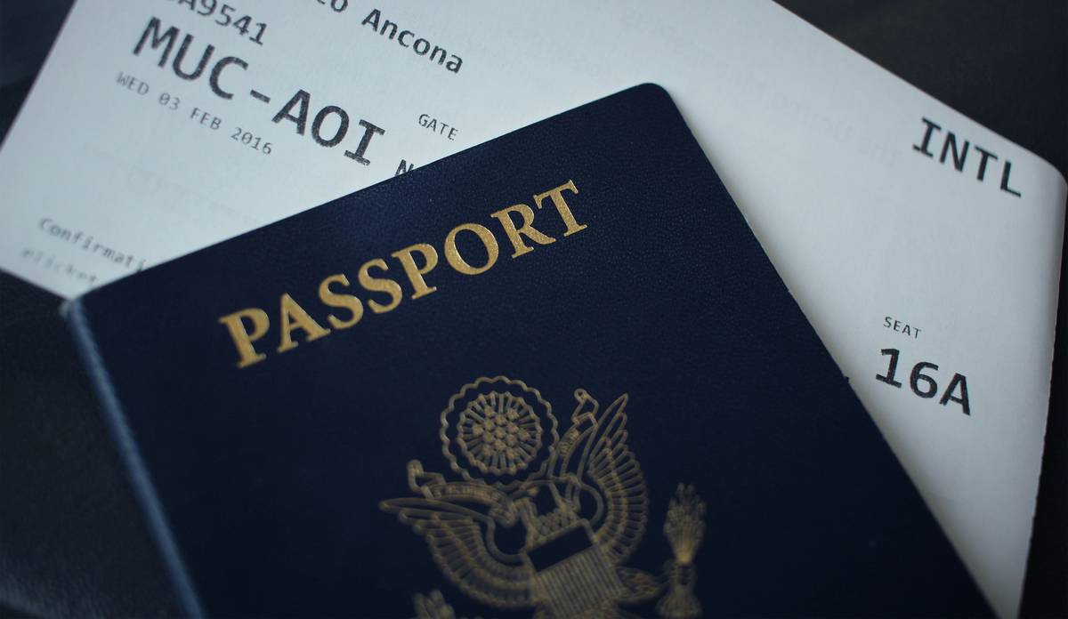 Traveler using phone to check Multi-Currency Wallet Insurance coverage while abroad