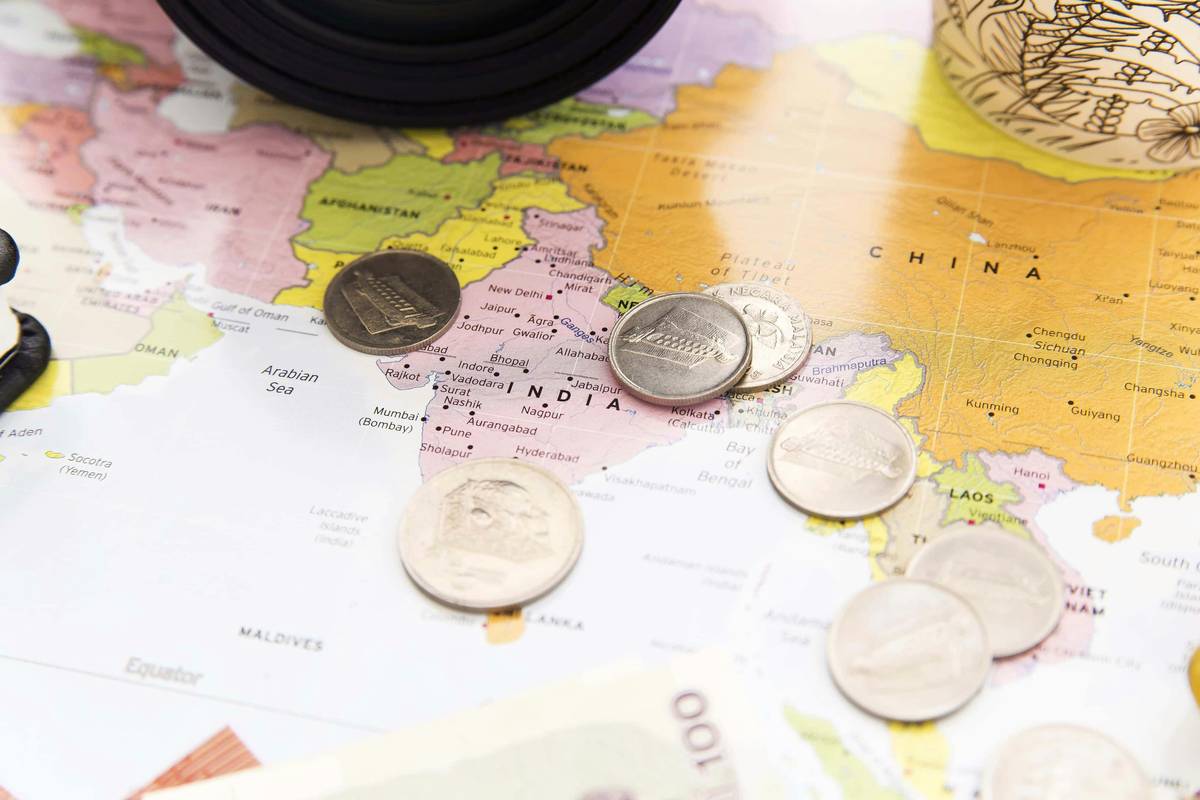 Traveler checking currency app showing poor my money exchange rate at airport kiosk