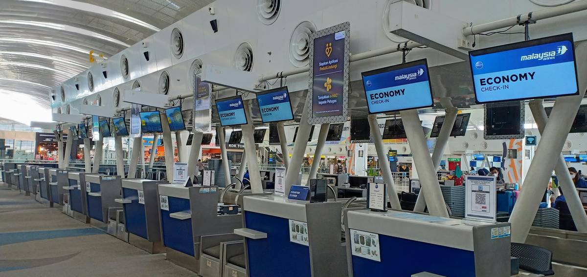 the travel money exchange process showing traveler using ATM with currency rate display